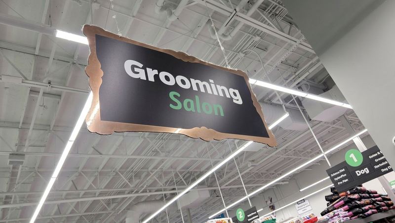 A Grooming Salon sign hanging over the store
